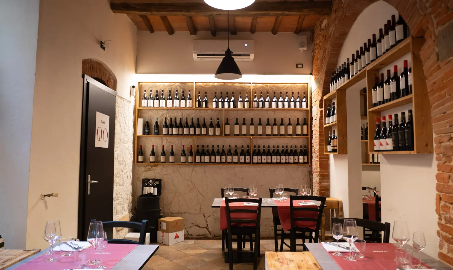 La sala del ristorante InCarne di Pisa con i mattoni a vista e il pavimento in cotto
